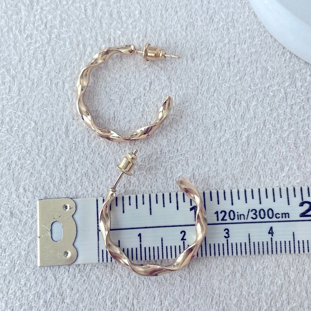Medium twisted hoop gold earrings